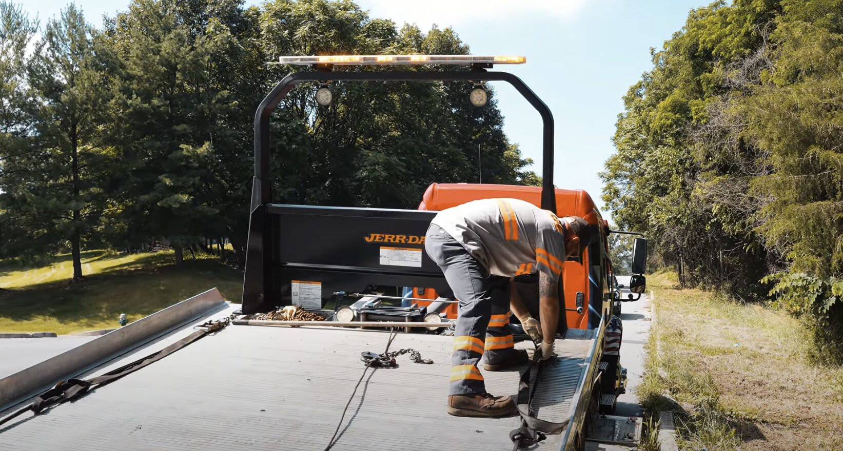 Professional Heavy-Duty Towing Equipment and Safety Procedures Heavy-duty towing equipment with professional operator securing chains on roadside