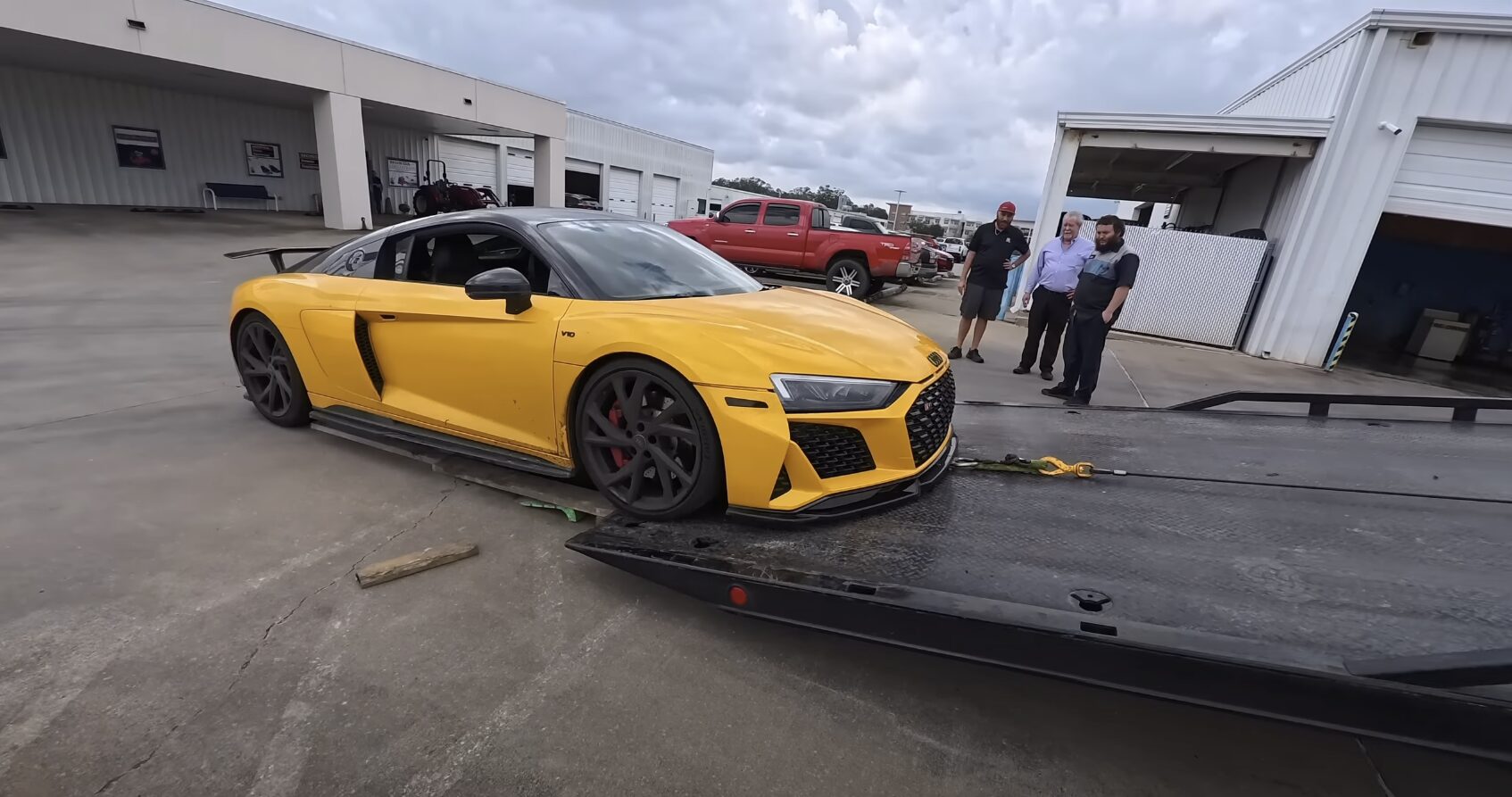 Professional flatbed towing service loading luxury sports car safely